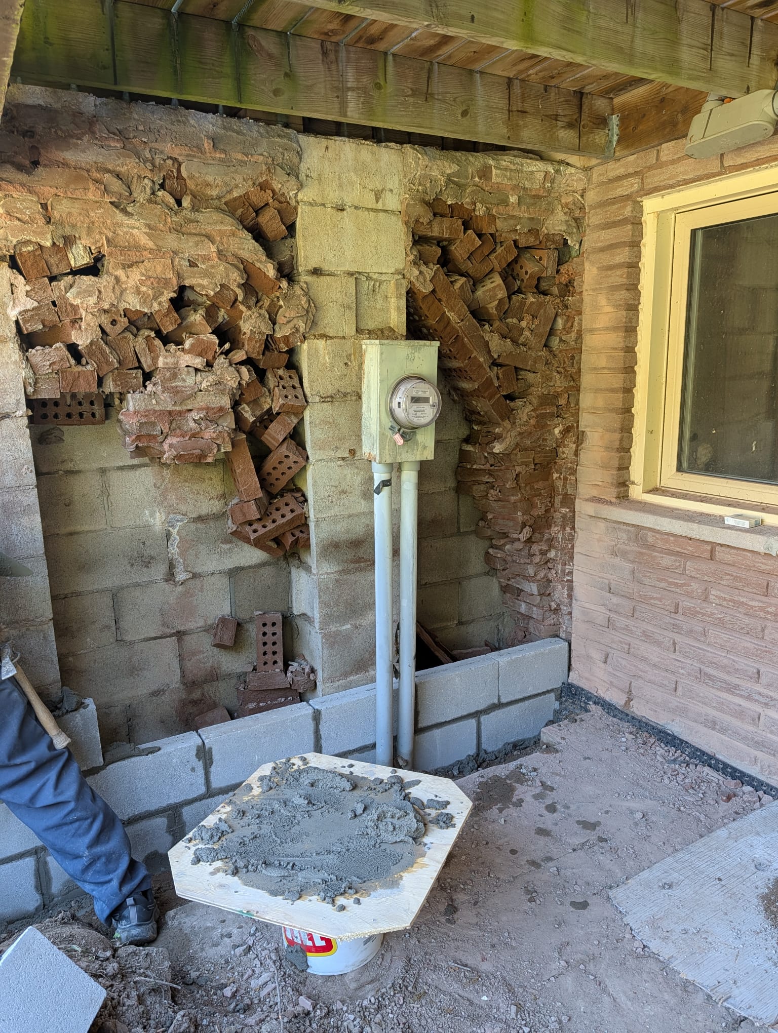 New concrete block courses laid beneath a porch where the old wall deteriorated