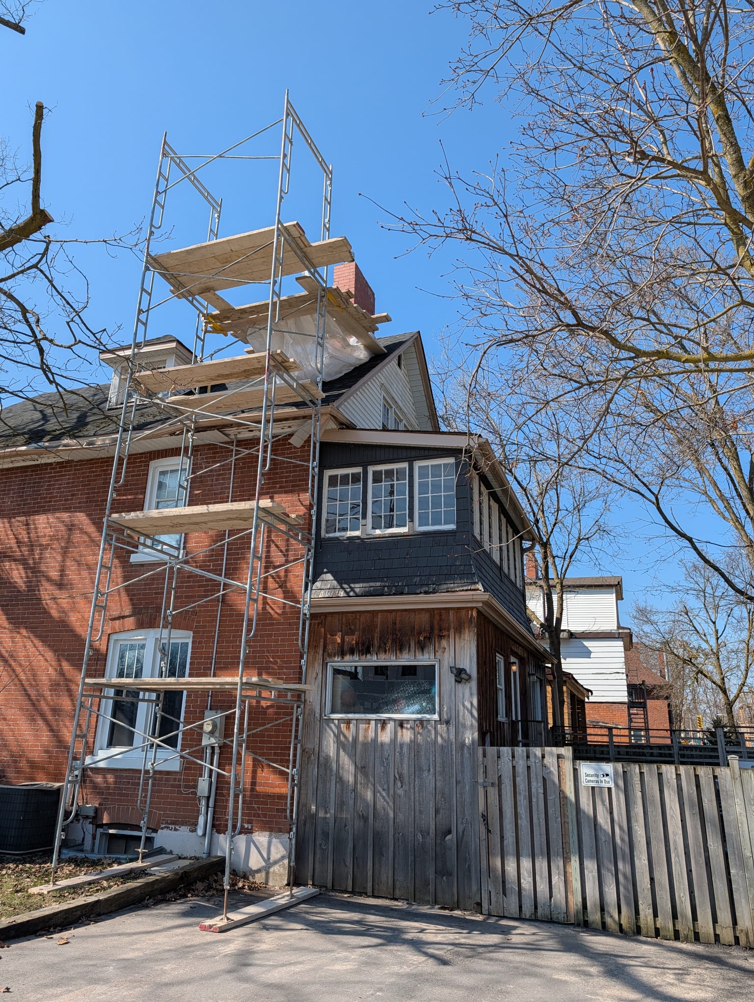 Scaffold tower built up the side of a Victorian house to the chimney